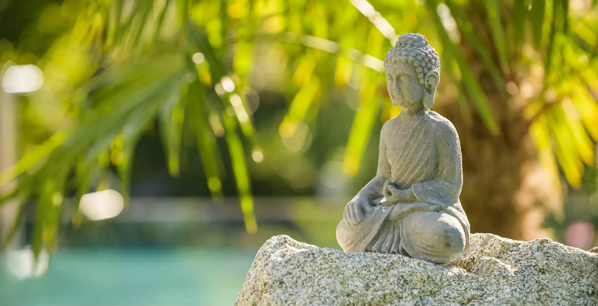 Buddhastatue aus Stein im mediterranen Garten